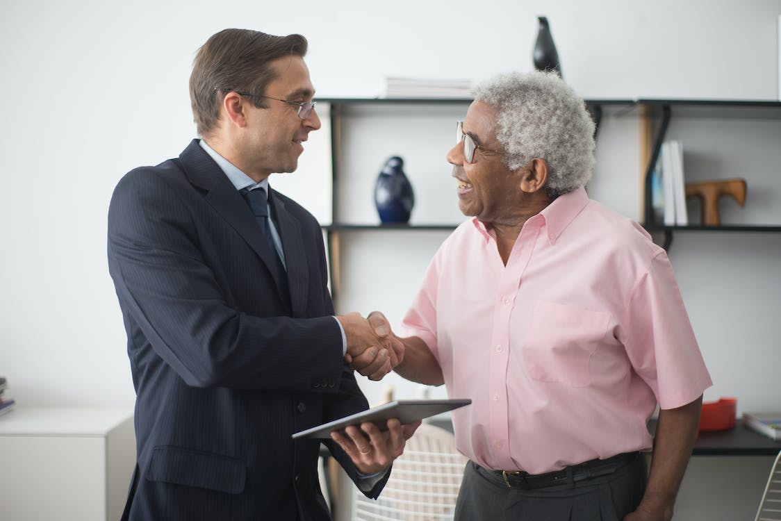 A public adjuster shaking hands with a client